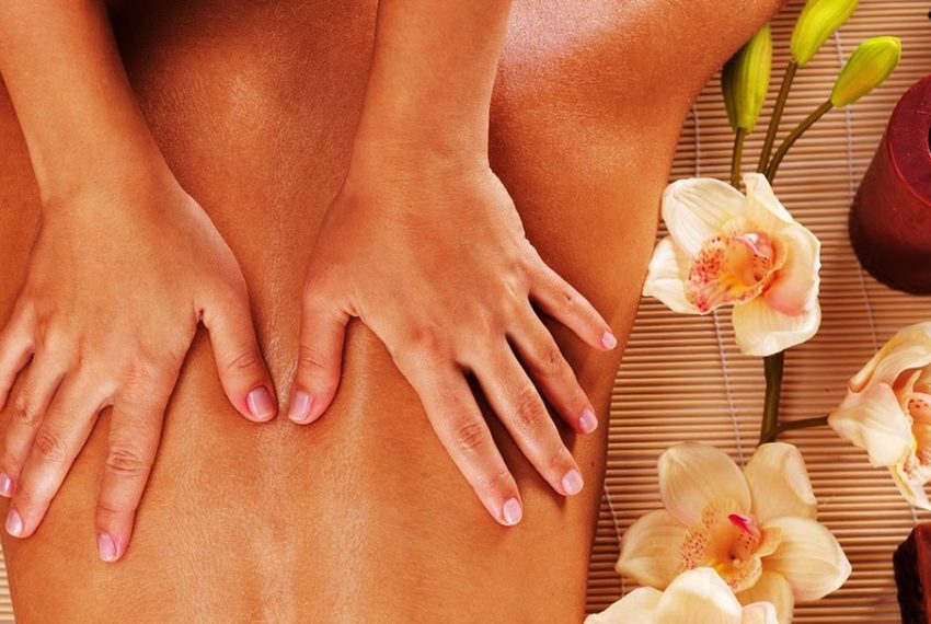 Masseur doing massage on woman back in the spa salon